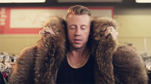 Macklemore dramatically putting on a coat in the music video "Thrift Shop."