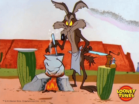 Wile E. Coyote with an apron stirring a bucket over a fire.