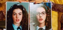 Mia from The Princess Diaries holding her "before and after makeover" photos.
