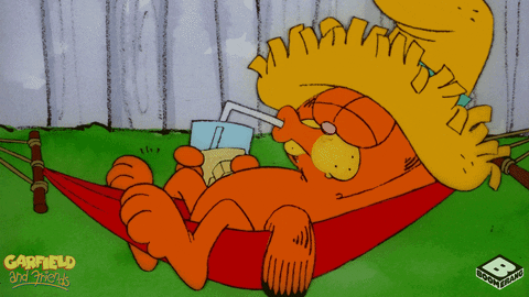 Garfield relaxing in a hammock drinking juice.