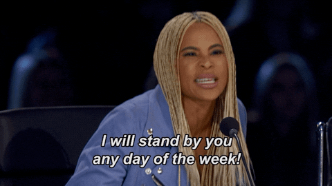 Woman standing up and saying, "I will stand by you any day of the week."