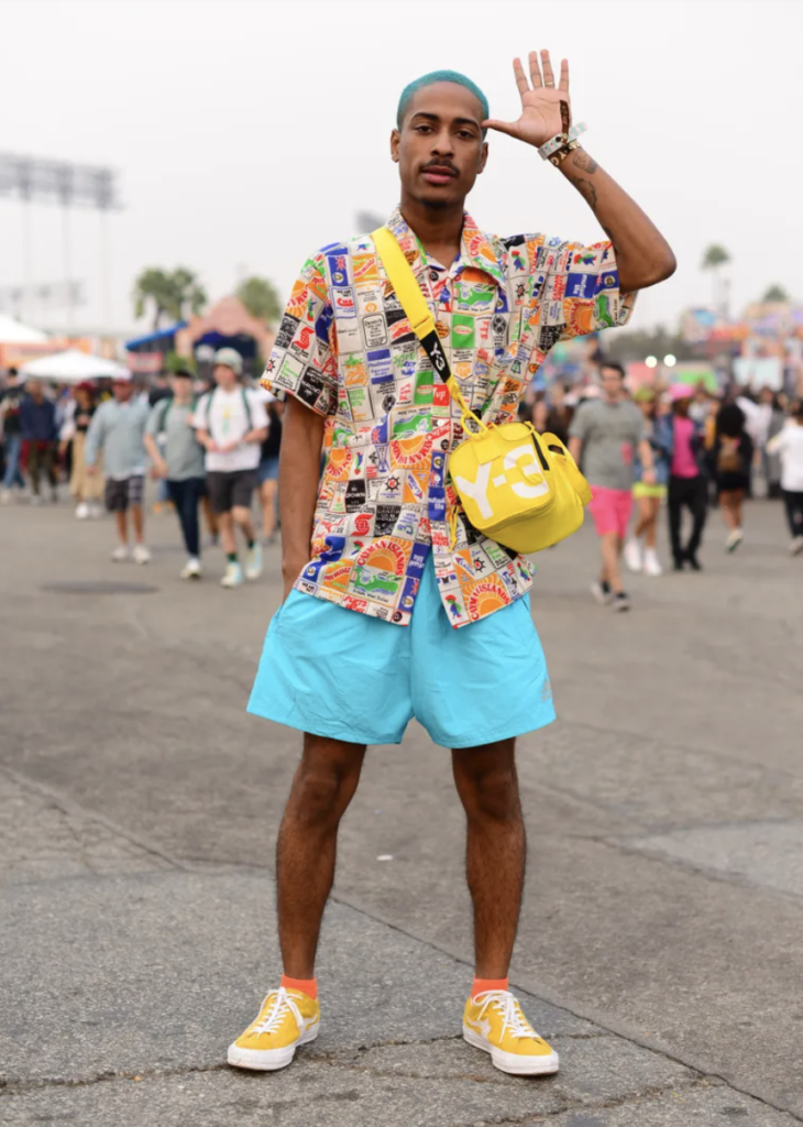 Man at music festival in coloured fashion.