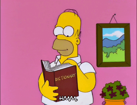 Homer, from the Simpsons is flipping the pages of a dictionary gif