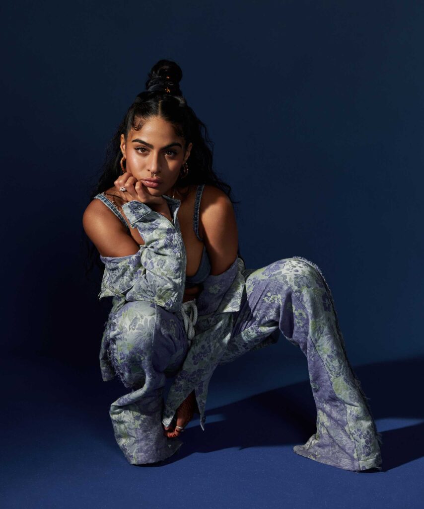 Jessie Reyez one of the Canadian artists dressed in a floral two-piece outfit.