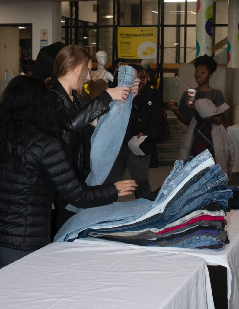 Sustainable fashion students setting up for sustainability event.