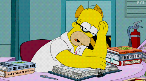 Homer from the Simpsons is flipping the pages of a book.