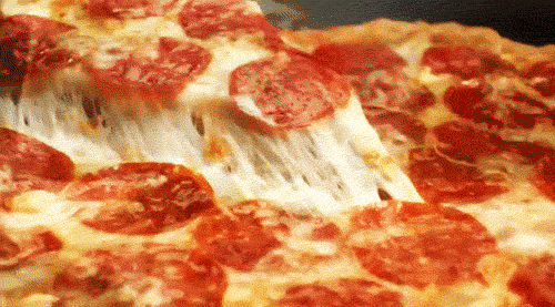 A slice of pepperoni pizza is being lifted slowly. (Food spots)