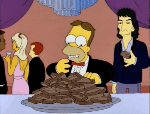 A character from Simpsons is eating a lot of brownies. (Food spots)