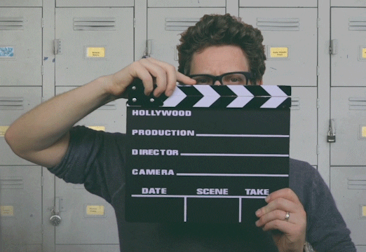 A man is using a movie film clapboard.