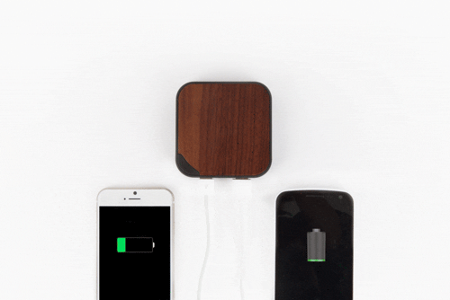 Two phones are connected to a wireless charger.