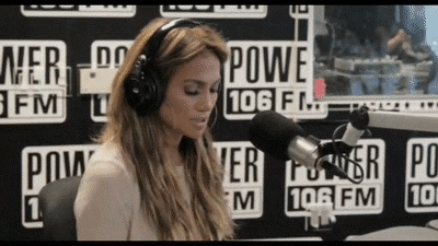 Jennifer Lopez is listening to music through headphones. (backpack essentials)