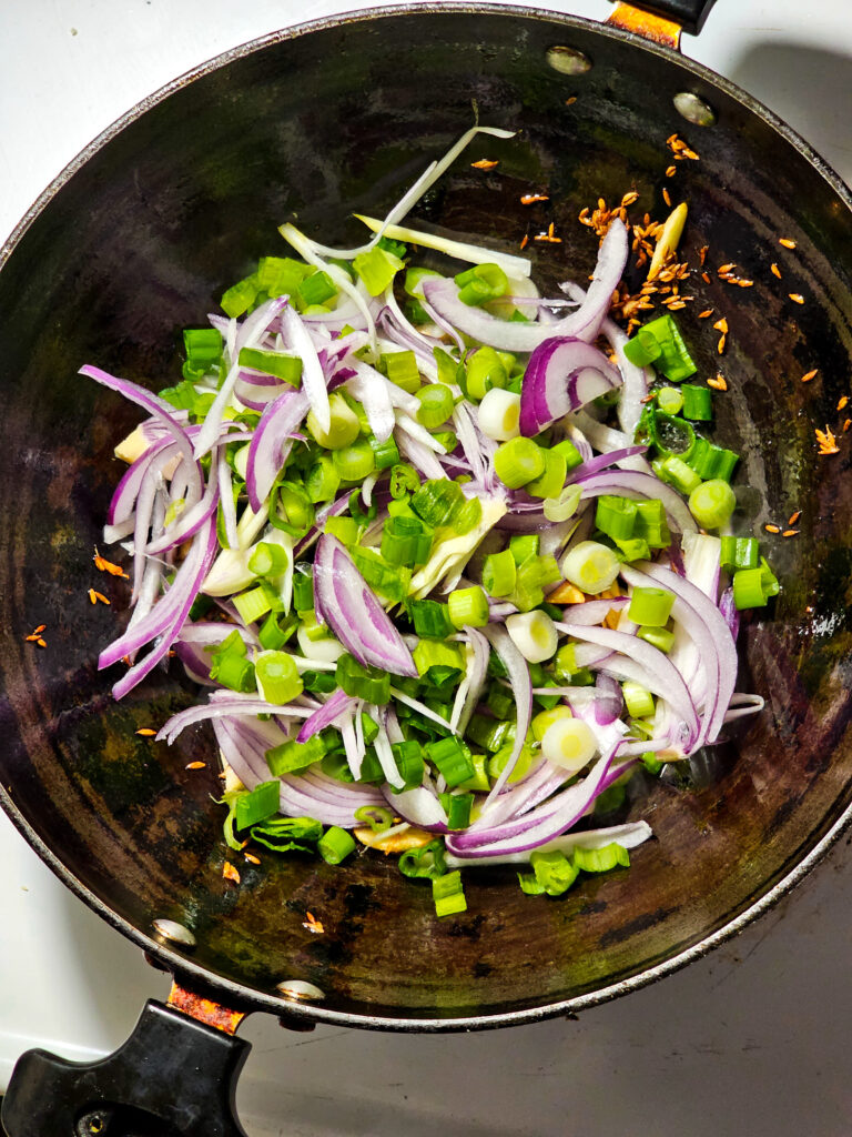 red and green onion in a pan