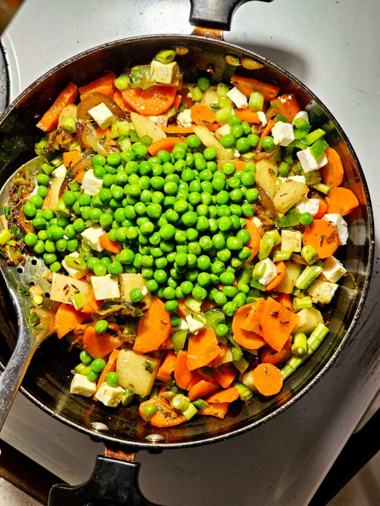 green peas added to a pan