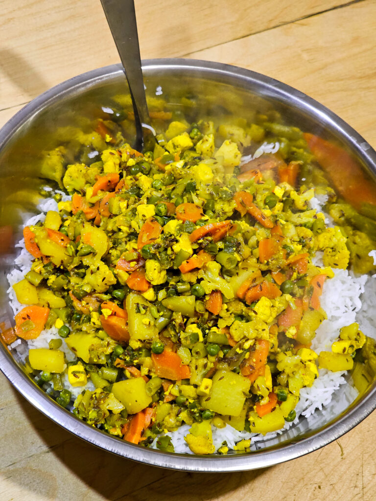 rice and vegetables combined in a mixing bowl