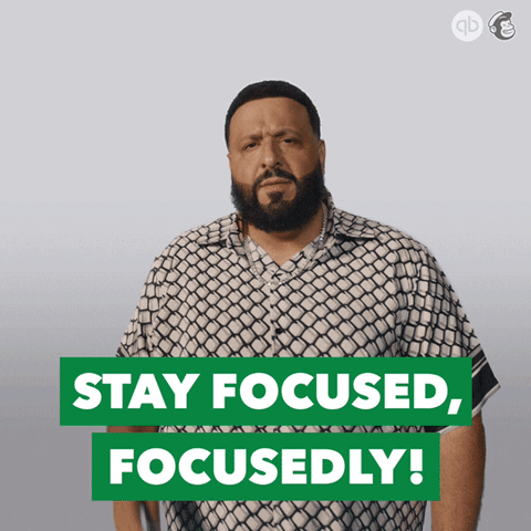 Dj Khaled is saying "stay focused."
He is dressed in a geometric shirt.