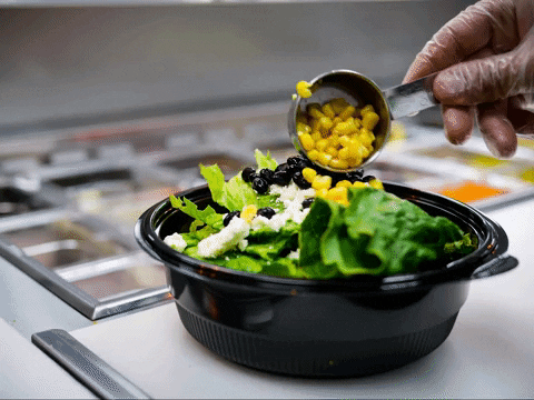A salad bowl with lettuce, corn and black beans. 

Lunch Salad Gif 