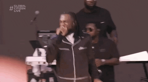 Burna Boy is dressed in black and performing at a concert.

Burna Boy Concert GIF