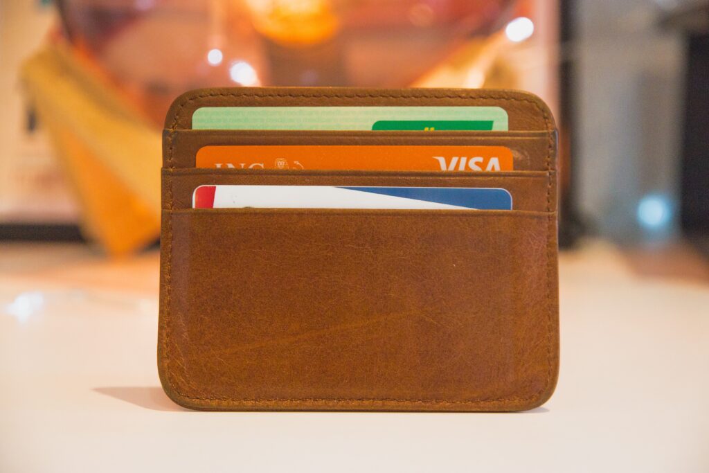 A brown wallet is filled with credit and debit cards.
