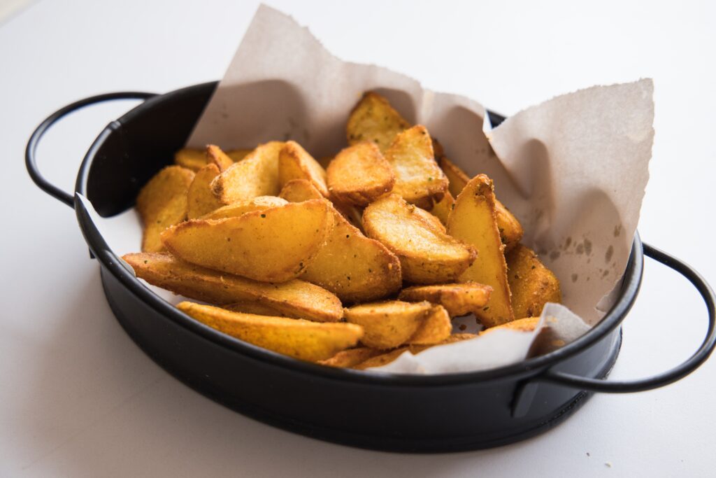 A bowl of seasoned potato wedges.   It is a popular side dish to serve with soup.