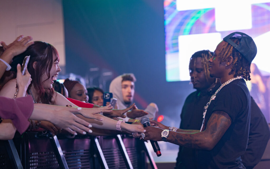 Rich the Kid holding hands with fans at IGNITE Concert 2023.