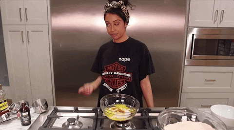 Liza Koshy making entertaining gestures while cooking.