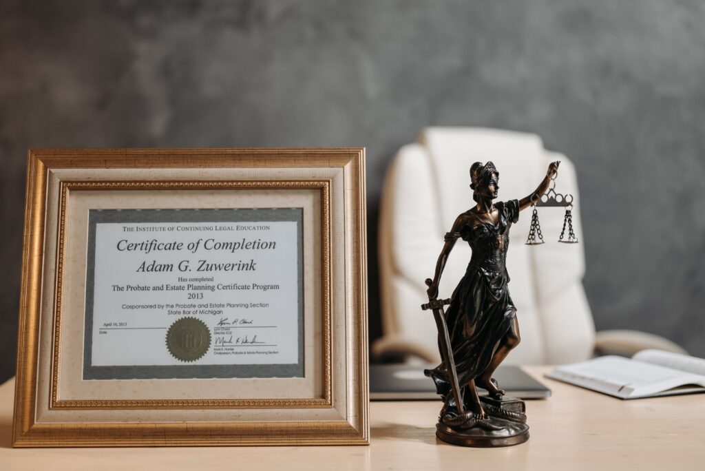 A certificate of completion framed and displayed on a desk. 