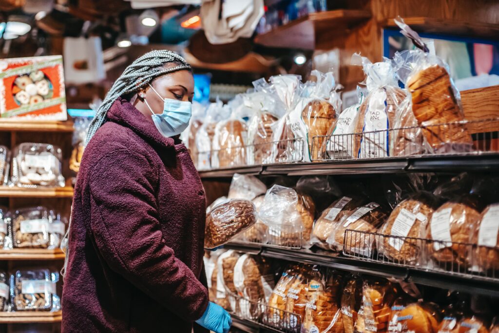 Black woman buying bread in supermarket