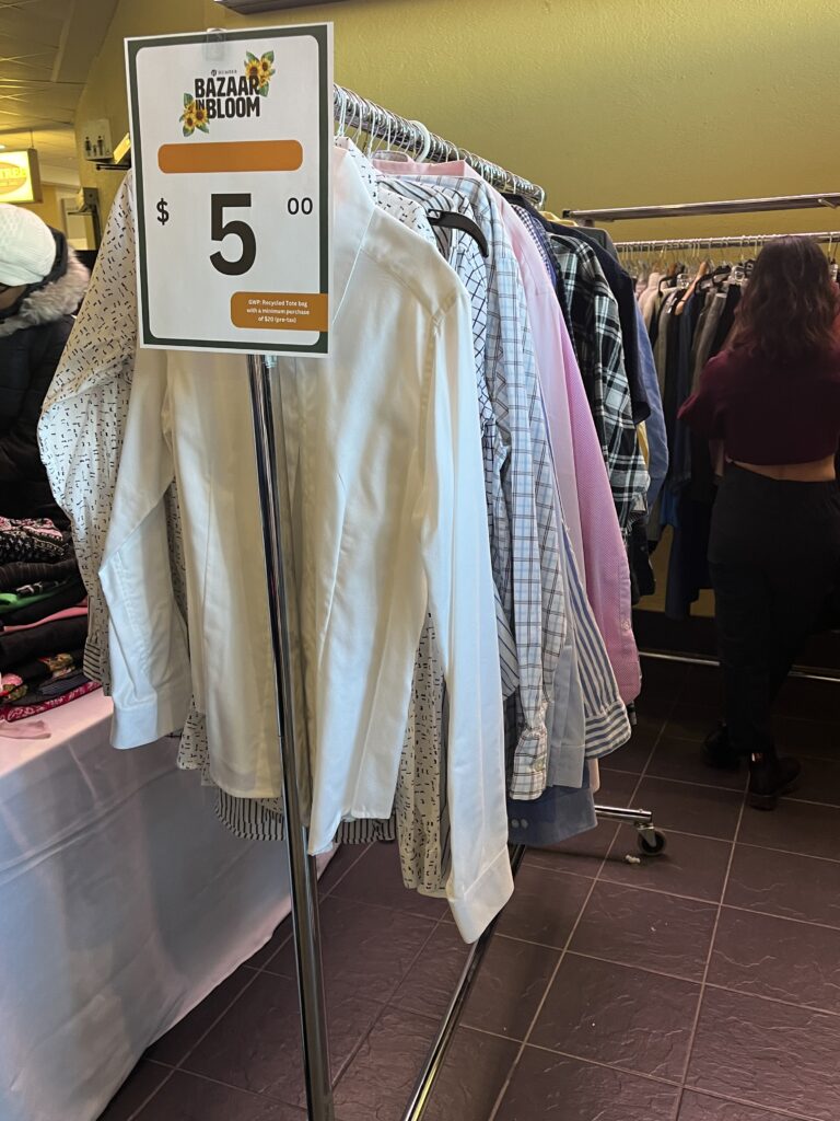 A clothing rack with different formal shirts available for sale.