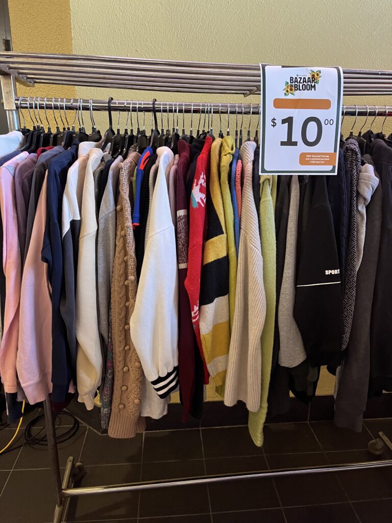 A clothing rack of different hoodies on sale. (Eco closet)