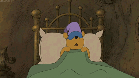 Cartoon character tucked into bed.