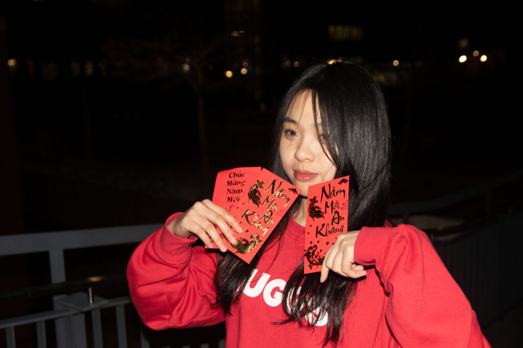 a cute girl holding red envelopes in Lunar New Year