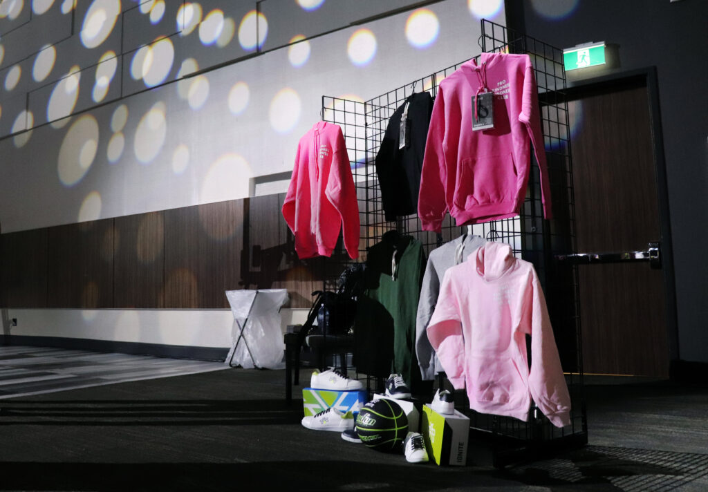 A picture of a clothing display of hoodies and sneakers at IGNITE's Hype Hall.