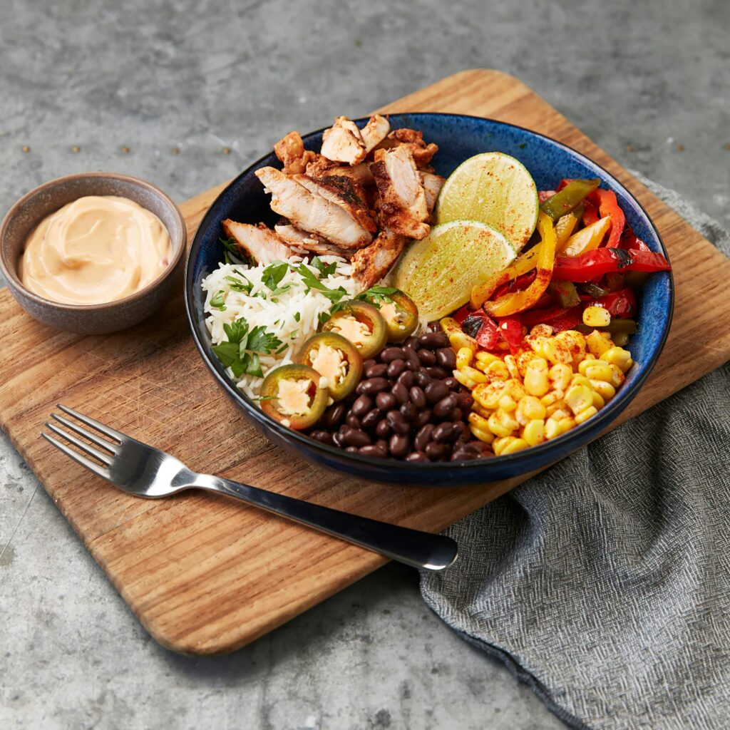 A serving of Chipotle's burrito bowl which includes corn, black beans, chicken and rice. 