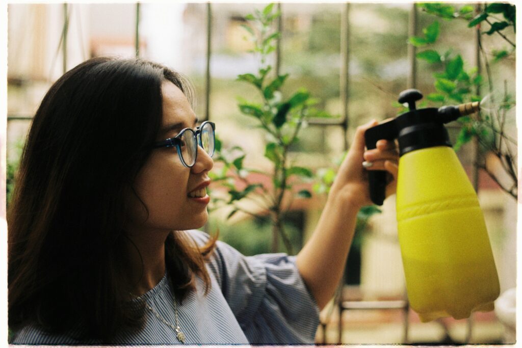 Woman watering a plant.