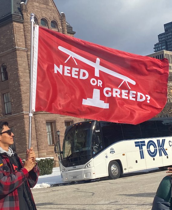 A banner displaying "Need or Greed" organized by IGNITE student advocates to protest tuition increases for international students.