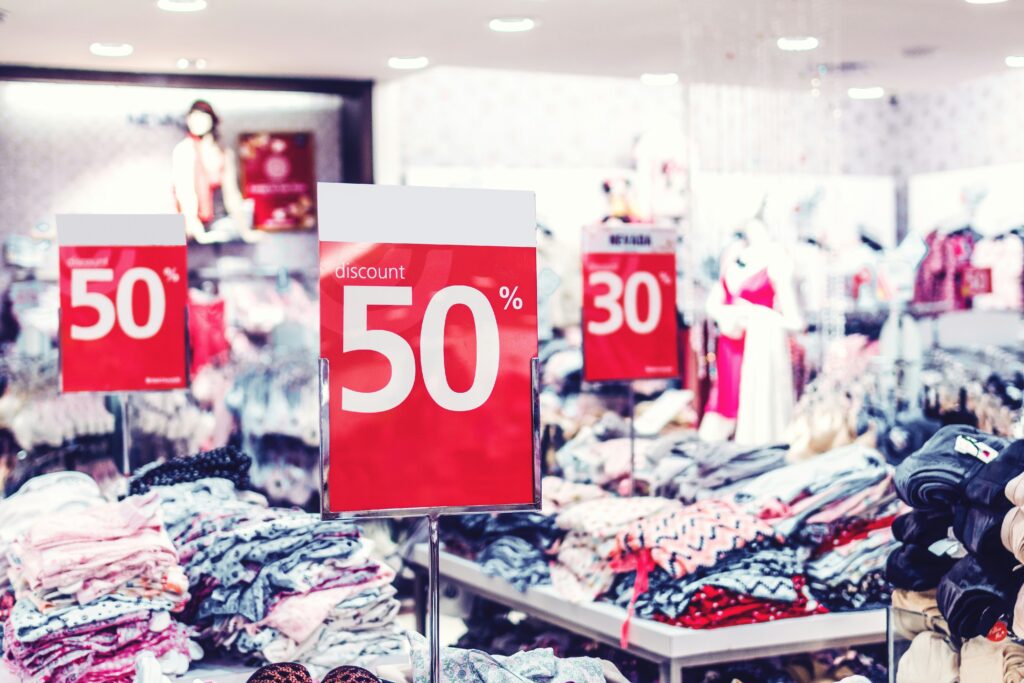 Picture of a department store with 50 and 30 per cent off signs.