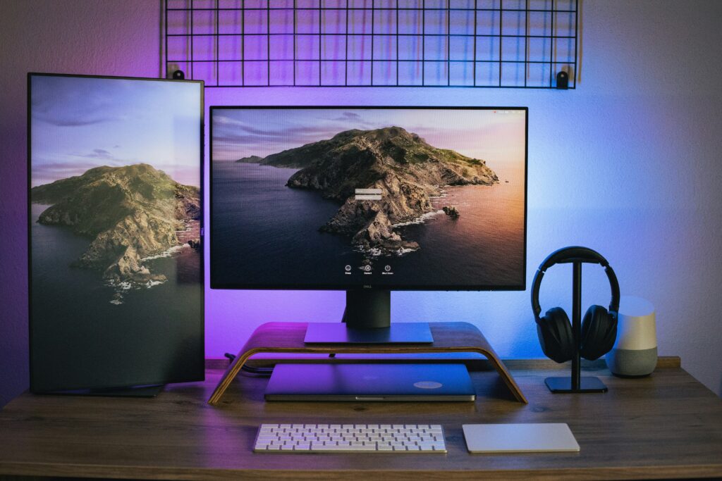 Picture of a black and gray laptop computer on a brown wooden table.