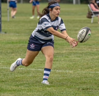 Picture of Lara Pallonji playing Rugby.