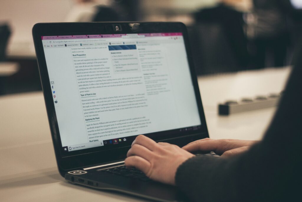 Picture of a person writing a blog on a laptop.