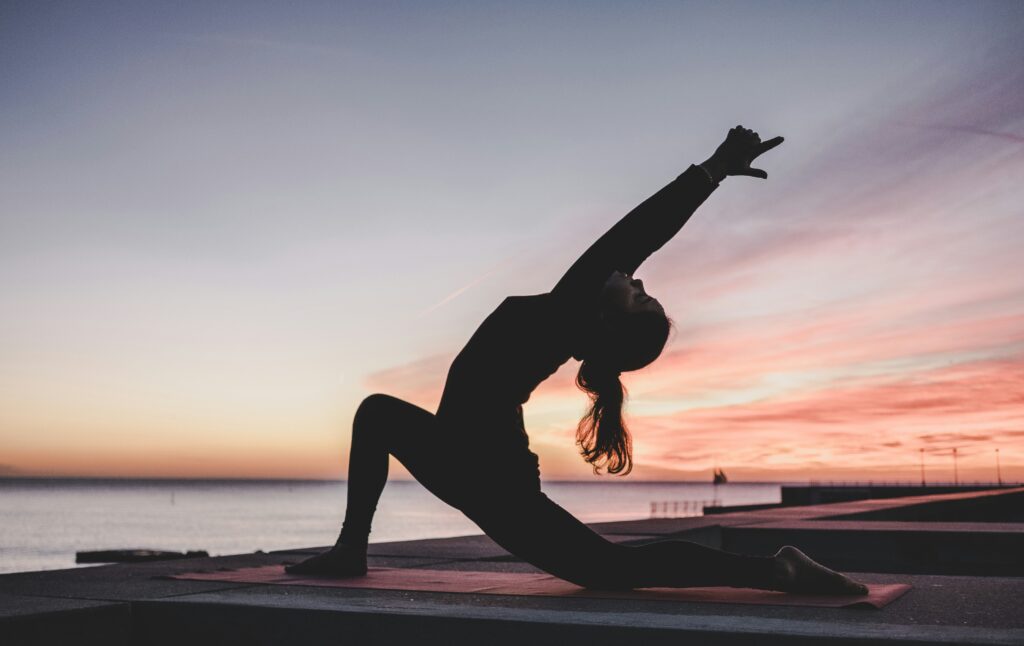 Picture of a silhouette of a woman doing yoga.