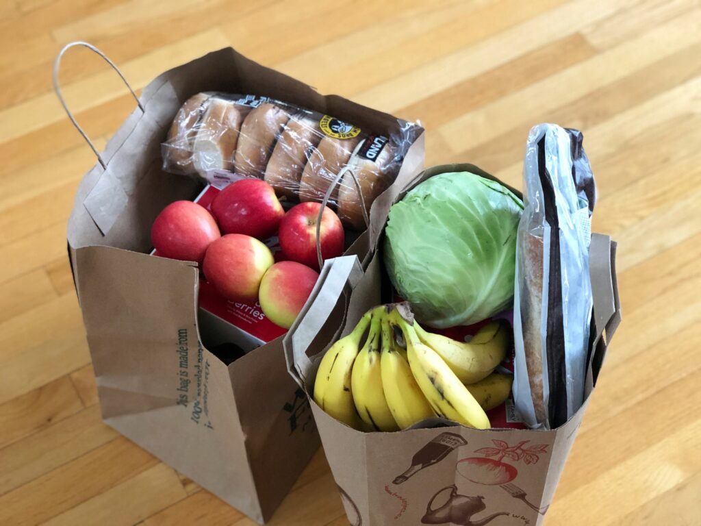 Picture of groceries in brown cardboard boxes.