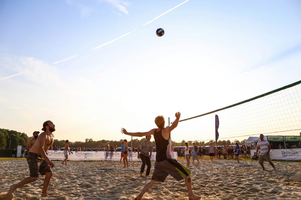 Picture of a group of people playing beach volleyball.