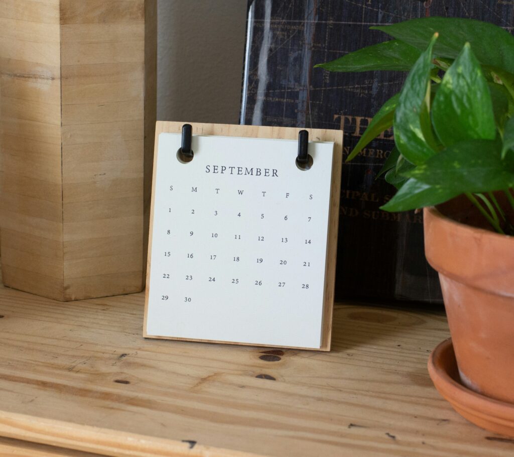 A September paper calendar on top of a wooden table.