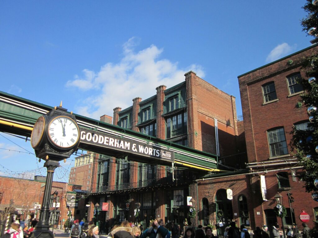 Picture of a crowd standing near Gooderham and Worts Building in the Distillery District.