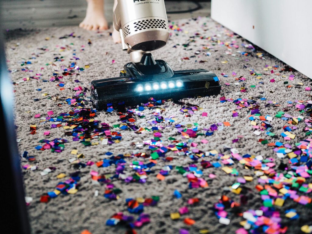 A person vacuuming a carpet.