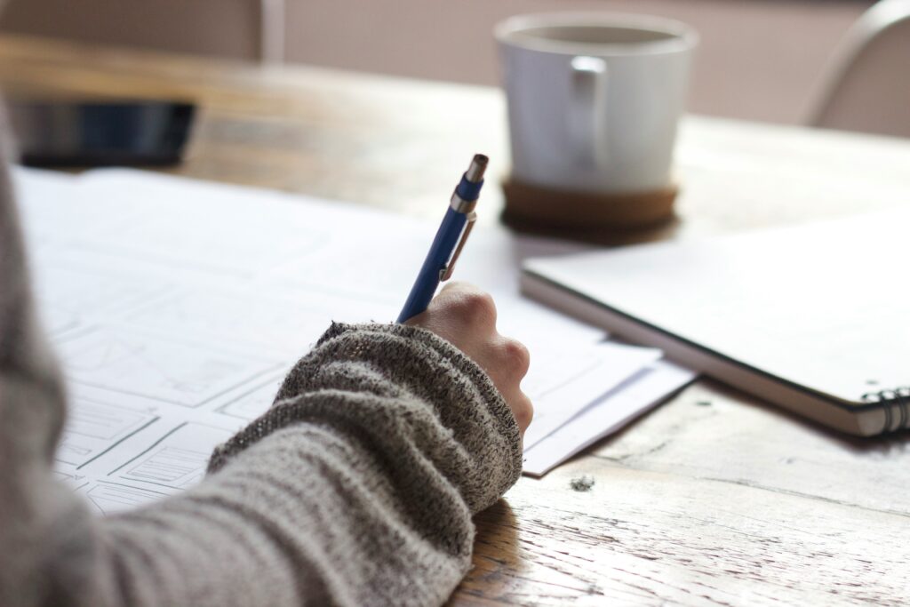 A person writing on a piece of paper.