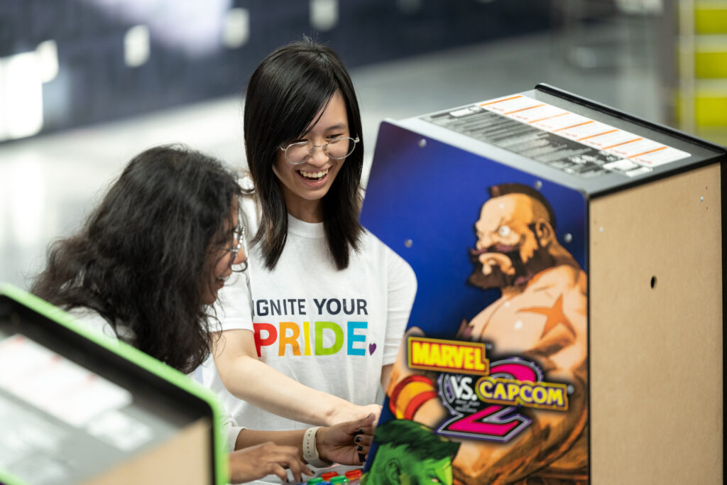 A Student and an IGNITE brand ambassador playing an arcade game.