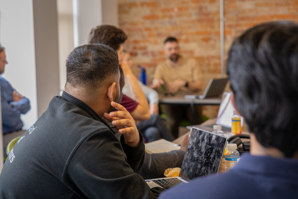 A close-up from the back of someone in a meeting.