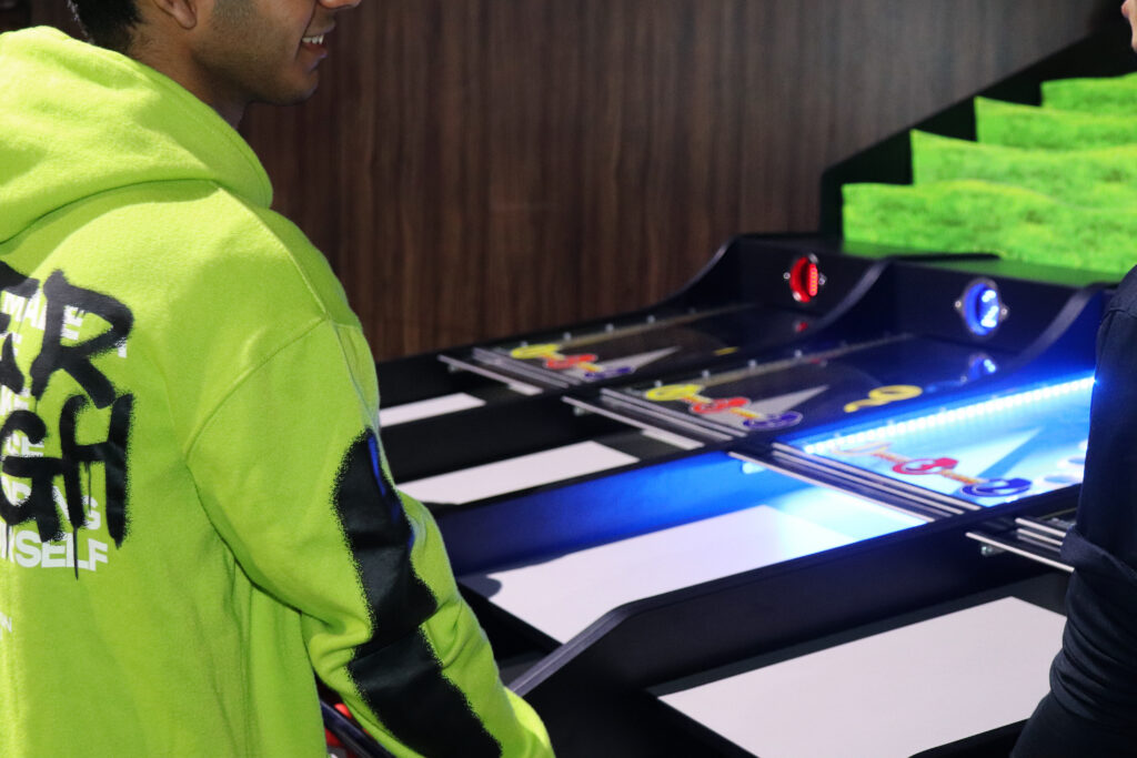 A boy playing an arcade game during IGNITE Concert.