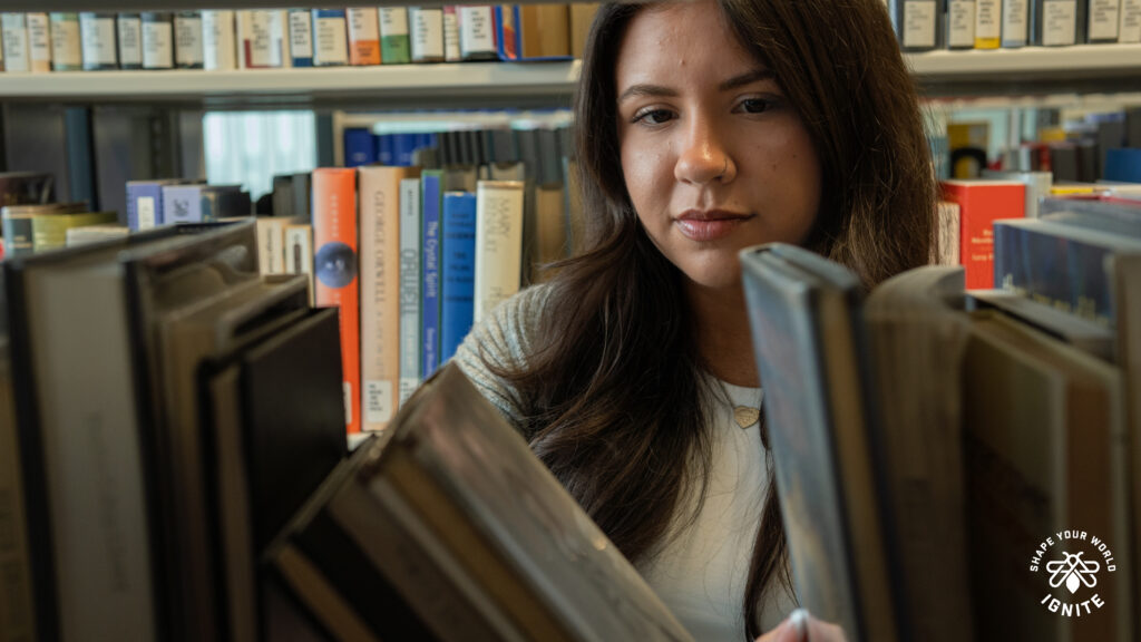 Student browsing brooks at the library.